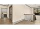 Hallway features hardwood flooring, a small wet bar, and natural light at 8159 Fairview Rd, Charlotte, NC 28226