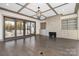 Bright living room with sliding glass doors to the outside with modern fireplace and coffered ceilings at 8159 Fairview Rd, Charlotte, NC 28226