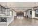 Open-concept living area with a fireplace, stylish light fixtures, and sliding doors at 8159 Fairview Rd, Charlotte, NC 28226