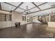 Open-concept living room featuring a fireplace, cabinets, windows, and a staircase at 8159 Fairview Rd, Charlotte, NC 28226
