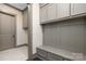 Functional mudroom featuring built-in bench seating and storage cabinets at 8159 Fairview Rd, Charlotte, NC 28226