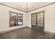 Elegant office space with glass French doors and a stylish chandelier at 8159 Fairview Rd, Charlotte, NC 28226