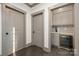 Compact wet bar featuring gray cabinets, subway tile backsplash, and wine fridge at 8159 Fairview Rd, Charlotte, NC 28226
