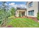 Beautifully landscaped backyard with a covered patio, lush lawn, and manicured gardens, perfect for outdoor living at 8163 Fairview Rd, Charlotte, NC 28226