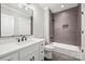 Bathroom featuring a white vanity, dark fixtures, and a shower over the tub with gray subway tile at 8163 Fairview Rd, Charlotte, NC 28226
