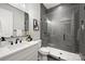 Modern bathroom with sleek gray tile shower, vanity, black fixtures, and contemporary design for a luxurious experience at 8163 Fairview Rd, Charlotte, NC 28226