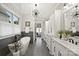 Spa-like bathroom featuring a soaking tub, double vanity, and modern lighting fixtures at 8163 Fairview Rd, Charlotte, NC 28226