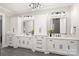 Bright bathroom featuring and vanities, quartz countertops, and modern lighting fixtures at 8163 Fairview Rd, Charlotte, NC 28226