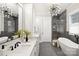Luxurious bathroom with double vanity, soaking tub, a glass enclosed shower, and modern accents at 8163 Fairview Rd, Charlotte, NC 28226