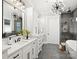 Luxurious bathroom with double vanity, soaking tub, a glass enclosed shower, and modern accents at 8163 Fairview Rd, Charlotte, NC 28226