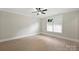 A bright bedroom featuring wood floors, a ceiling fan, neutral walls and a window to let in natural light at 8163 Fairview Rd, Charlotte, NC 28226