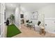 Inviting bonus room with golf simulator, comfortable seating, and stylish decor, perfect for relaxation and recreation at 8163 Fairview Rd, Charlotte, NC 28226