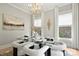 Bright dining room featuring a glass table, stylish lighting, and comfortable upholstered chairs at 8163 Fairview Rd, Charlotte, NC 28226
