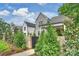 Charming exterior view of a home featuring brick accents, a manicured lawn, and tasteful landscaping at 8163 Fairview Rd, Charlotte, NC 28226