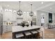 Beautiful white kitchen featuring pendant lighting, stainless appliances, and quartz countertops at 8163 Fairview Rd, Charlotte, NC 28226