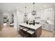 Spacious kitchen featuring a large island with seating, modern lighting, and stainless steel appliances at 8163 Fairview Rd, Charlotte, NC 28226