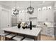 Modern kitchen with a large island, pendant lighting, stainless steel appliances, and white cabinetry at 8163 Fairview Rd, Charlotte, NC 28226