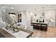 Open-concept kitchen and dining area, featuring a large island with seating and modern appliances at 8163 Fairview Rd, Charlotte, NC 28226