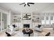 Bright living room featuring a fireplace, custom built-ins, and two accent chairs at 8163 Fairview Rd, Charlotte, NC 28226