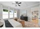 Cozy main bedroom featuring three bright windows, a tray ceiling, and a dark wood dresser at 8163 Fairview Rd, Charlotte, NC 28226