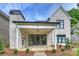 Inviting covered patio with an outdoor fireplace, offering a perfect space for relaxation and entertaining guests at 8163 Fairview Rd, Charlotte, NC 28226
