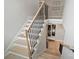 Elegant staircase with wooden treads, black iron railings, and modern design, connecting multiple levels of the home at 8163 Fairview Rd, Charlotte, NC 28226