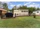Fenced backyard featuring a grill, a small porch and a house in a distance at 225 Shore Acres Rd, Salisbury, NC 28146