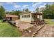 Charming backyard featuring a wooden structure, small porch and gravel-covered area at 225 Shore Acres Rd, Salisbury, NC 28146