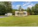 Charming cottage-style home with a well-maintained lawn, shed, and inviting front porch at 225 Shore Acres Rd, Salisbury, NC 28146