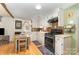 Bright kitchen with white cabinets, stainless steel appliances, and a cozy breakfast nook at 225 Shore Acres Rd, Salisbury, NC 28146