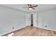 Bedroom featuring hardwood floors, a ceiling fan, and ample closet space at 506 E Maine Ave, Bessemer City, NC 28016
