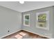 Bright bedroom with hardwood floors and two large windows allowing ample natural light at 506 E Maine Ave, Bessemer City, NC 28016