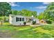 Well-maintained home featuring a landscaped yard, painted white brick, and detached garage at 506 E Maine Ave, Bessemer City, NC 28016
