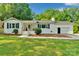 Charming home featuring a covered front porch, white brick, and beautifully landscaped yard at 506 E Maine Ave, Bessemer City, NC 28016