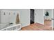 Inviting hallway with stylish coat rack and bench, and hardwood flooring at 506 E Maine Ave, Bessemer City, NC 28016