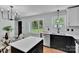 Modern kitchen featuring black and white cabinetry, an island, and stainless steel appliances at 506 E Maine Ave, Bessemer City, NC 28016