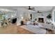 Open-concept living room with hardwood floors, fireplace, and views into the dining and kitchen areas at 506 E Maine Ave, Bessemer City, NC 28016