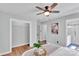 Cozy main bedroom featuring a ceiling fan, hardwood flooring, and ensuite bathroom access at 506 E Maine Ave, Bessemer City, NC 28016