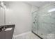 Bathroom featuring a frameless shower and marbled tile at 6043 Waldorf Ave, Monroe, NC 28110