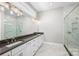 Bathroom featuring marble-look tile, frameless shower, and double vanity at 6043 Waldorf Ave, Monroe, NC 28110