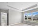 Bright room with tray ceiling, recessed lights, and ample natural light from three large windows at 6043 Waldorf Ave, Monroe, NC 28110