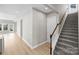 Bright entryway with hardwood floors, leading to a staircase with gray carpet at 6043 Waldorf Ave, Monroe, NC 28110