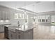 Bright, open-concept kitchen featuring a large island, modern pendant lighting, and stainless steel appliances at 6043 Waldorf Ave, Monroe, NC 28110