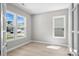 Sun-filled living room with wood-look flooring and large windows offering great natural light and neighborhood views at 6043 Waldorf Ave, Monroe, NC 28110