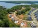 Aerial shot of a residential area with new home construction and a scenic lake nearby at 831 Lake Forest Dr # Savanh, Belmont, NC 28012