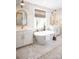 Elegant bathroom with a freestanding tub, marble walls, double sink vanities, and gold hardware accents at 841 Lake Forest Dr # Hawthorne, Belmont, NC 28012