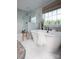 Bright bathroom featuring a soaking tub, an open shower with glass panel, and a large window at 841 Lake Forest Dr # Hawthorne, Belmont, NC 28012