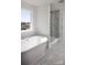 Bright, airy bathroom featuring a freestanding tub with shower at 841 Lake Forest Dr # Hawthorne, Belmont, NC 28012