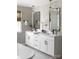 Modern bathroom with double vanity, a soaking tub, white cabinets, and herringbone tile accent wall at 841 Lake Forest Dr # Hawthorne, Belmont, NC 28012