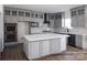 Stylish kitchen featuring a large island, gray cabinets, a black range hood, and modern finishes at 841 Lake Forest Dr # Hawthorne, Belmont, NC 28012